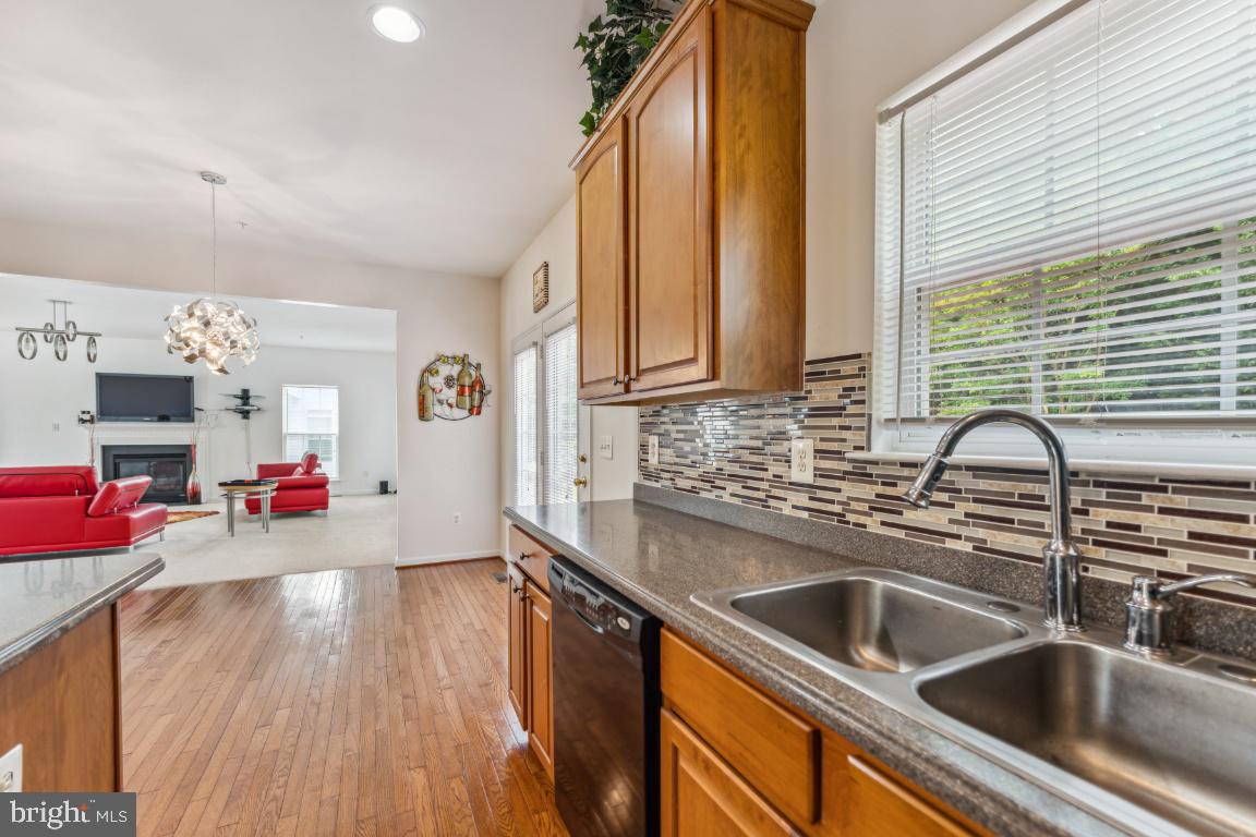 10103 Rolling Green Way Fort Washington, MD 20744 - Photo 11 of 39 a kitchen with stainless steel appliances a sink dishwasher and cabinets with wooden floor