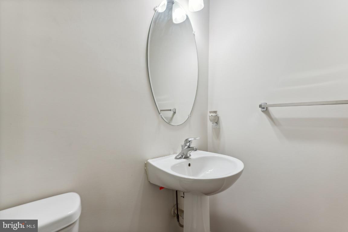 10103 Rolling Green Way Fort Washington, MD 20744 - Photo 19 of 39 a bathroom with a sink a mirror and a toilet