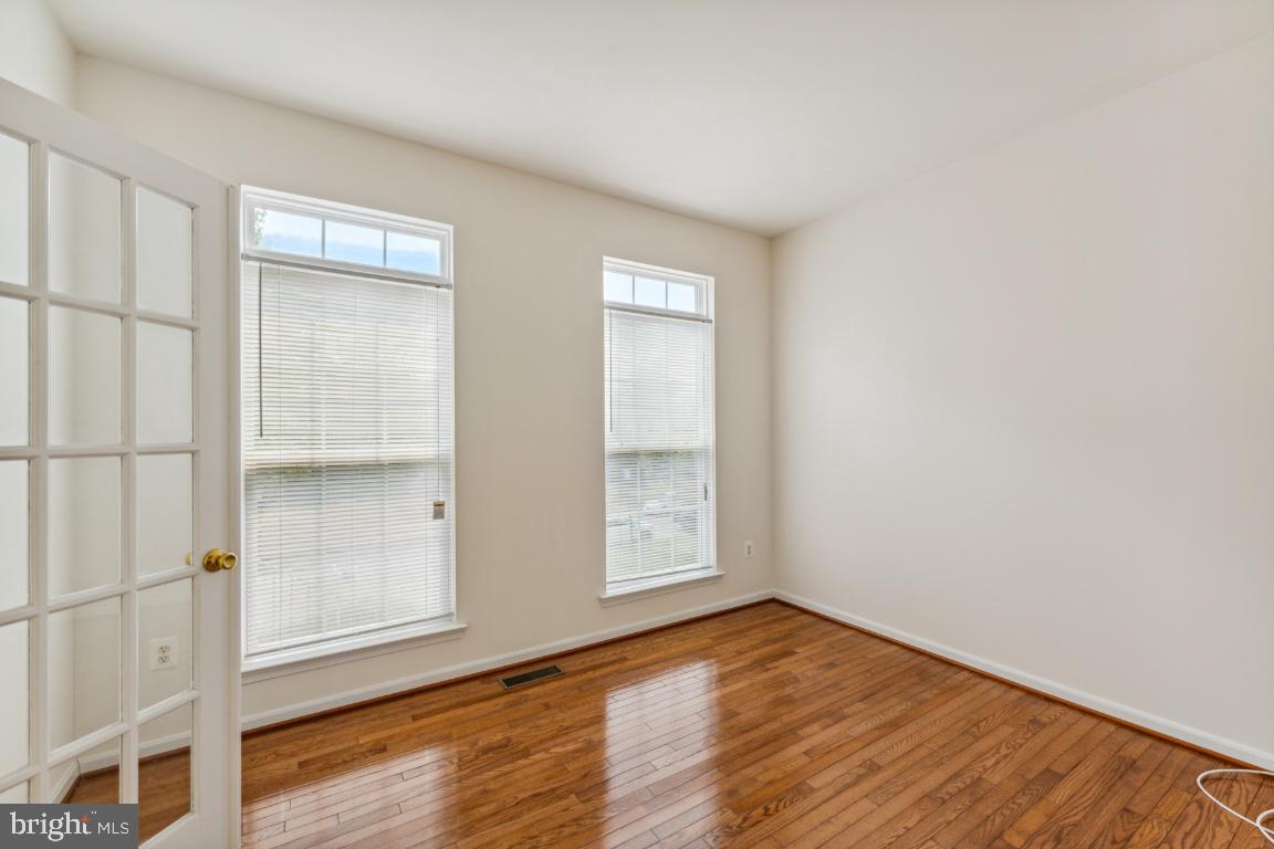 10103 Rolling Green Way Fort Washington, MD 20744 - Photo 5 of 39 an empty room with wooden floor and windows