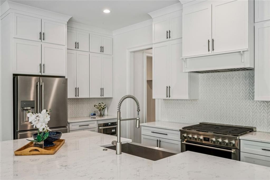 4081 Longleaf Lane Tucker, GA 30084 - Photo 11 of 49 a kitchen with stainless steel appliances granite countertop a sink stove and refrigerator