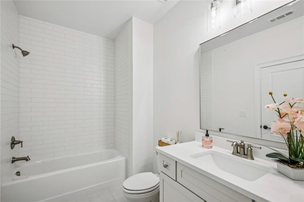 4081 Longleaf Lane Tucker, GA 30084 - Photo 26 of 49 a bathroom with a toilet a sink and a bathtub