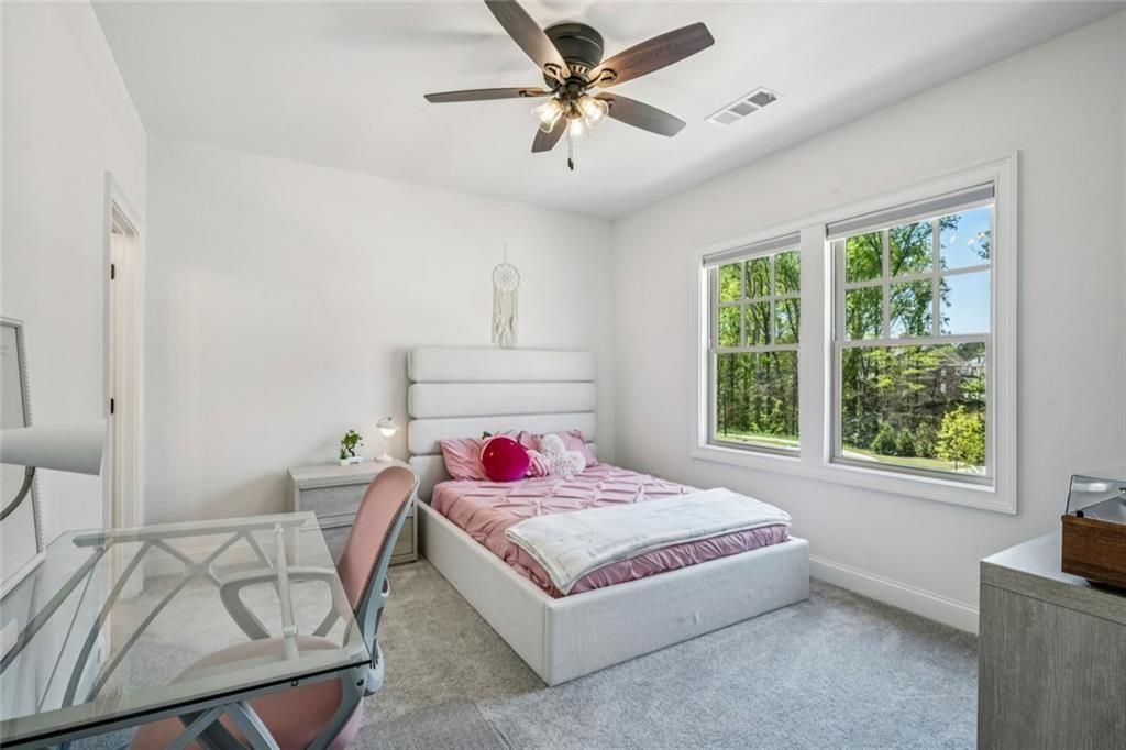 4081 Longleaf Lane Tucker, GA 30084 - Photo 28 of 49 a bedroom with a bed a couch and a chandelier
