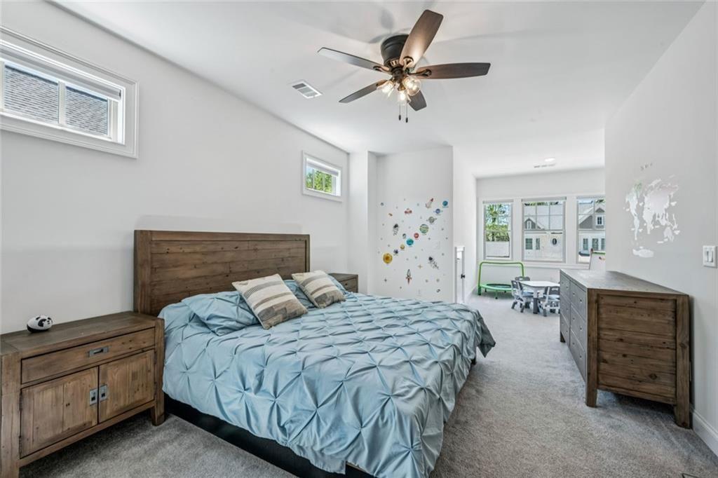 4081 Longleaf Lane Tucker, GA 30084 - Photo 34 of 49 a bedroom with a bed a dresser and chair