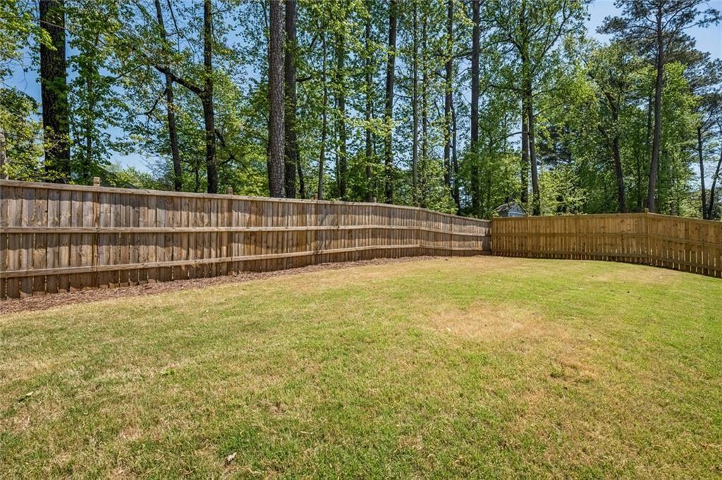4081 Longleaf Lane Tucker, GA 30084 - Photo 41 of 49 a view of backyard with swimming pool and trees in the background