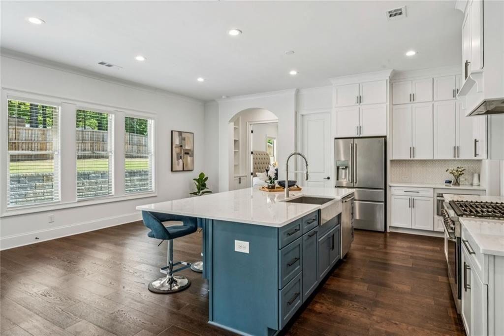 4081 Longleaf Lane Tucker, GA 30084 - Photo 9 of 49 a kitchen with kitchen island a sink stove and refrigerator