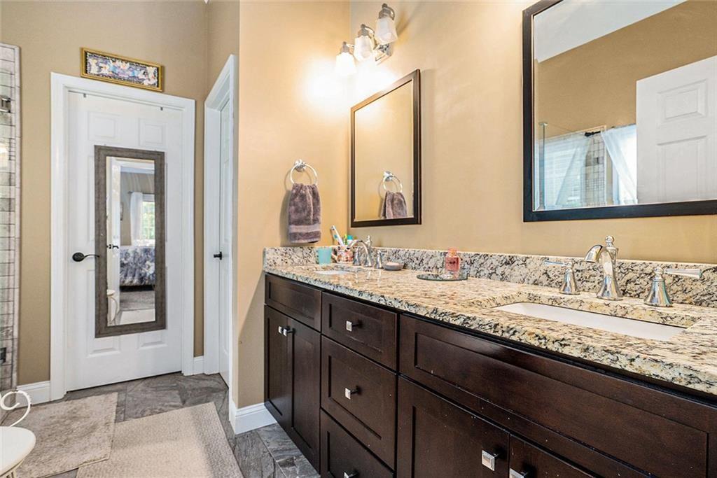 3792 Falls Trail Winston, GA 30187 - Photo 15 of 33 a bathroom with a granite countertop sink vanity mirror and