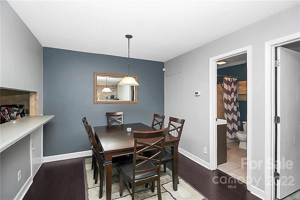 1612 Sharon Road West Charlotte, NC 28210 - Photo 12 of 25 a view of a dining room with furniture and wooden floor