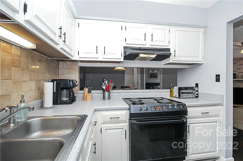 1612 Sharon Road West Charlotte, NC 28210 - Photo 14 of 25 a kitchen with stainless steel appliances granite countertop a stove and a sink