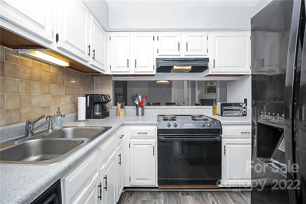 1612 Sharon Road West Charlotte, NC 28210 - Photo 15 of 25 a kitchen with stainless steel appliances granite countertop a sink stove and cabinets