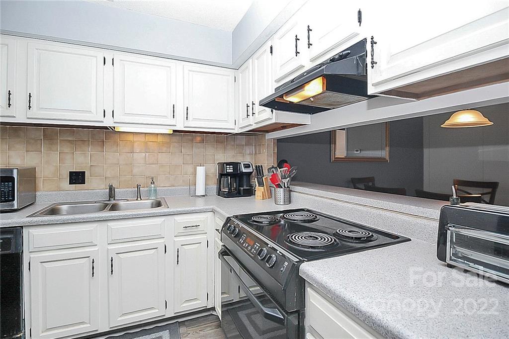 1612 Sharon Road West Charlotte, NC 28210 - Photo 17 of 25 a kitchen with stainless steel appliances granite countertop a sink stove and cabinets