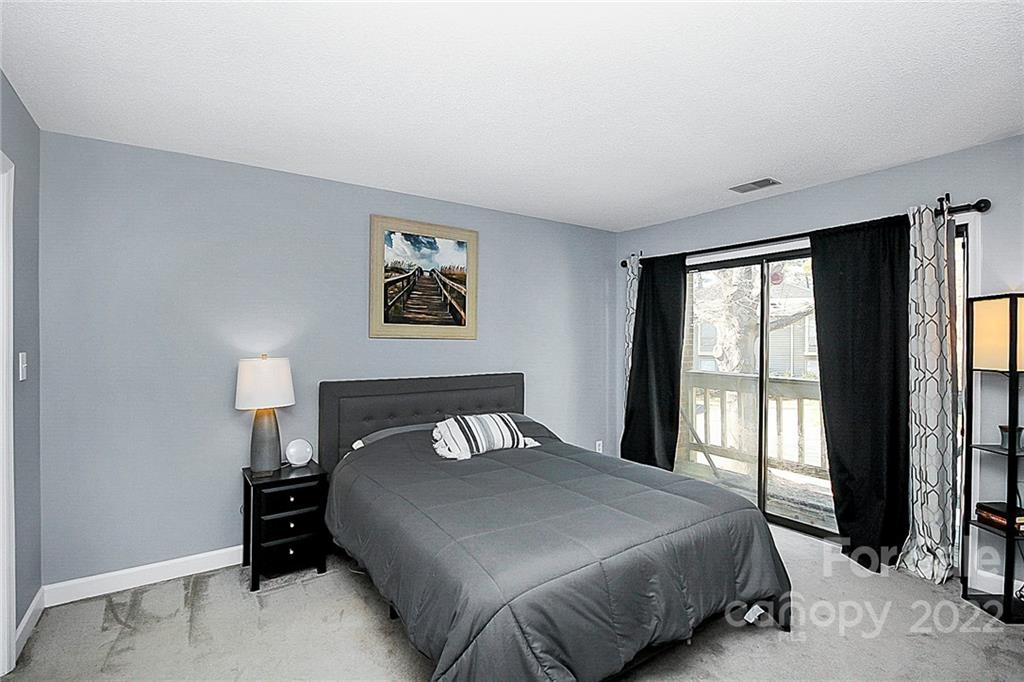1612 Sharon Road West Charlotte, NC 28210 - Photo 19 of 25 a bedroom with a large bed and a large window