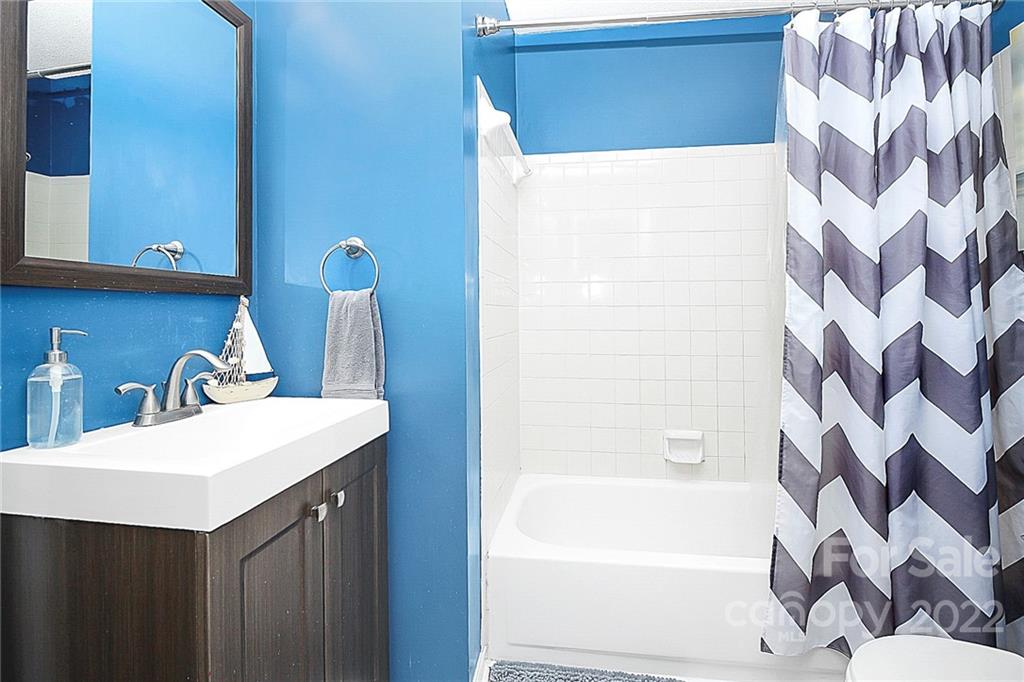 1612 Sharon Road West Charlotte, NC 28210 - Photo 20 of 25 a bathroom with a sink and a mirror