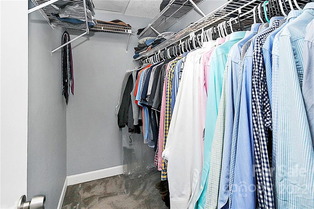 1612 Sharon Road West Charlotte, NC 28210 - Photo 21 of 25 a view of walk in closet with clothes and shoes