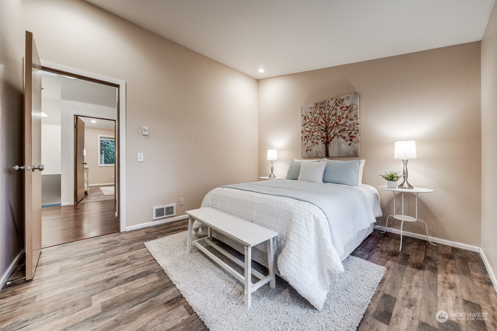 8512 242nd Street Southwest, Unit 9 Edmonds, WA 98026 - Photo 17 of 26 a bedroom with a bed and wooden floor