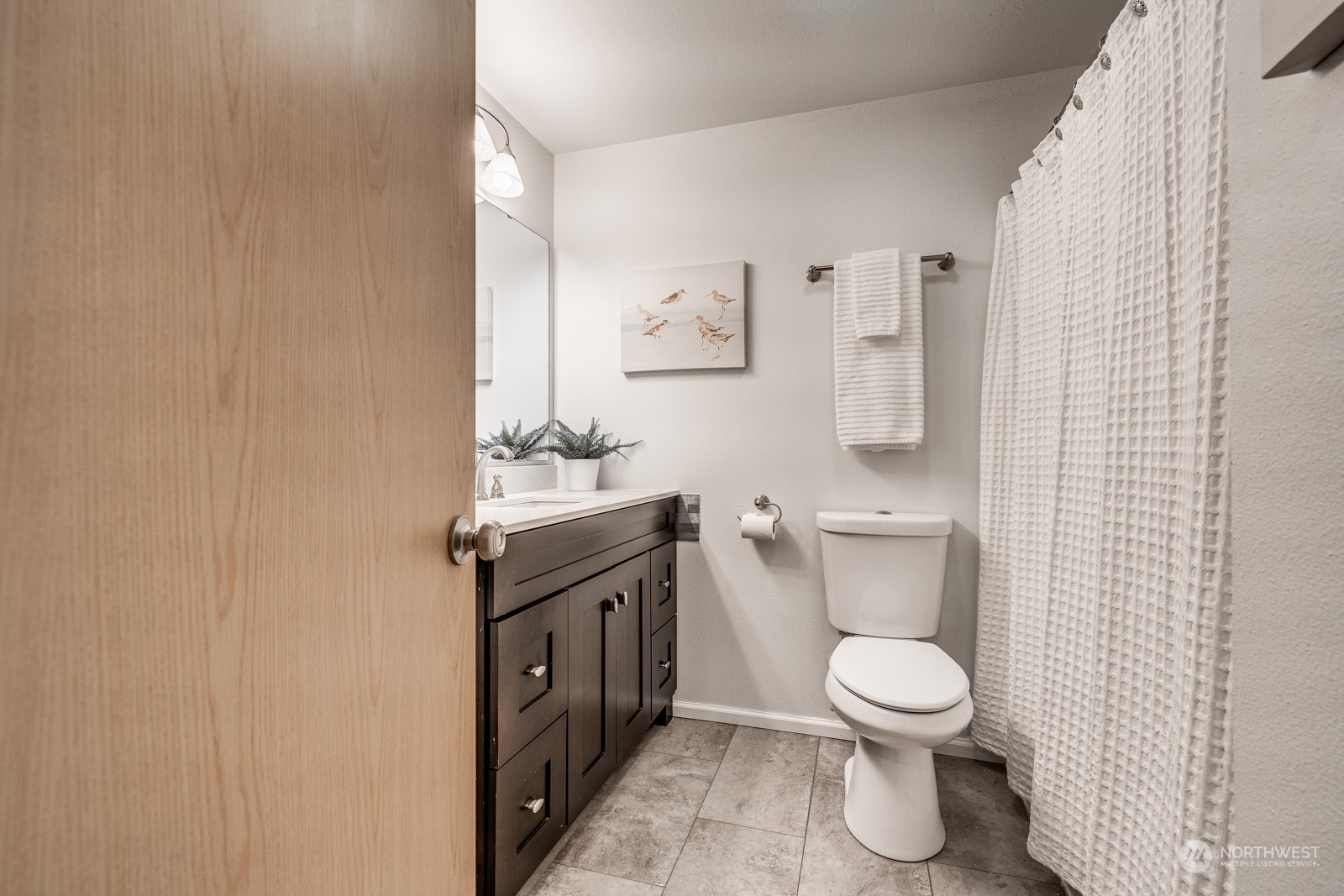8512 242nd Street Southwest, Unit 9 Edmonds, WA 98026 - Photo 19 of 26 a white toilet sitting next to a bathroom sink