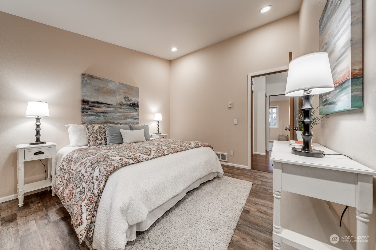 8512 242nd Street Southwest, Unit 9 Edmonds, WA 98026 - Photo 22 of 26 a spacious bedroom with a bed a mirror and lamp