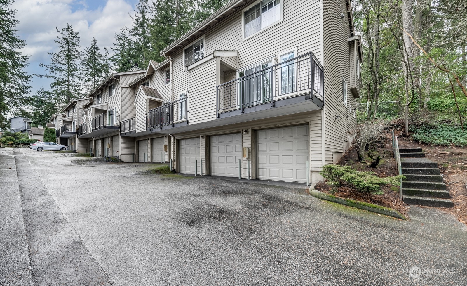 8512 242nd Street Southwest, Unit 9 Edmonds, WA 98026 - Photo 26 of 26 a view of a white house with large windows and a small yard