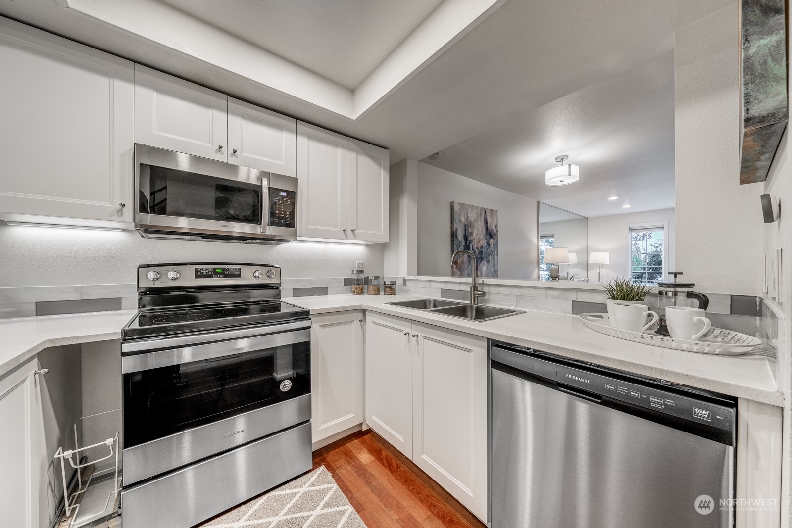 8512 242nd Street Southwest, Unit 9 Edmonds, WA 98026 - Photo 6 of 26 a kitchen with a sink stove and microwave