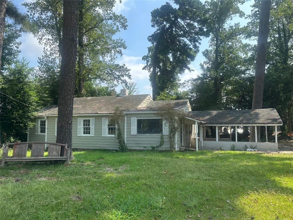 a front view of house with yard and green space