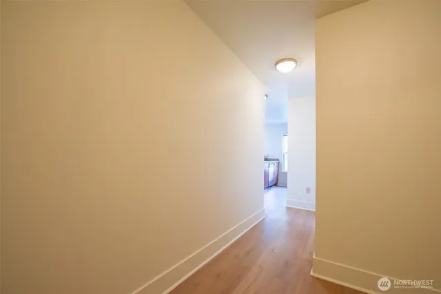 a view of a room with wooden floor