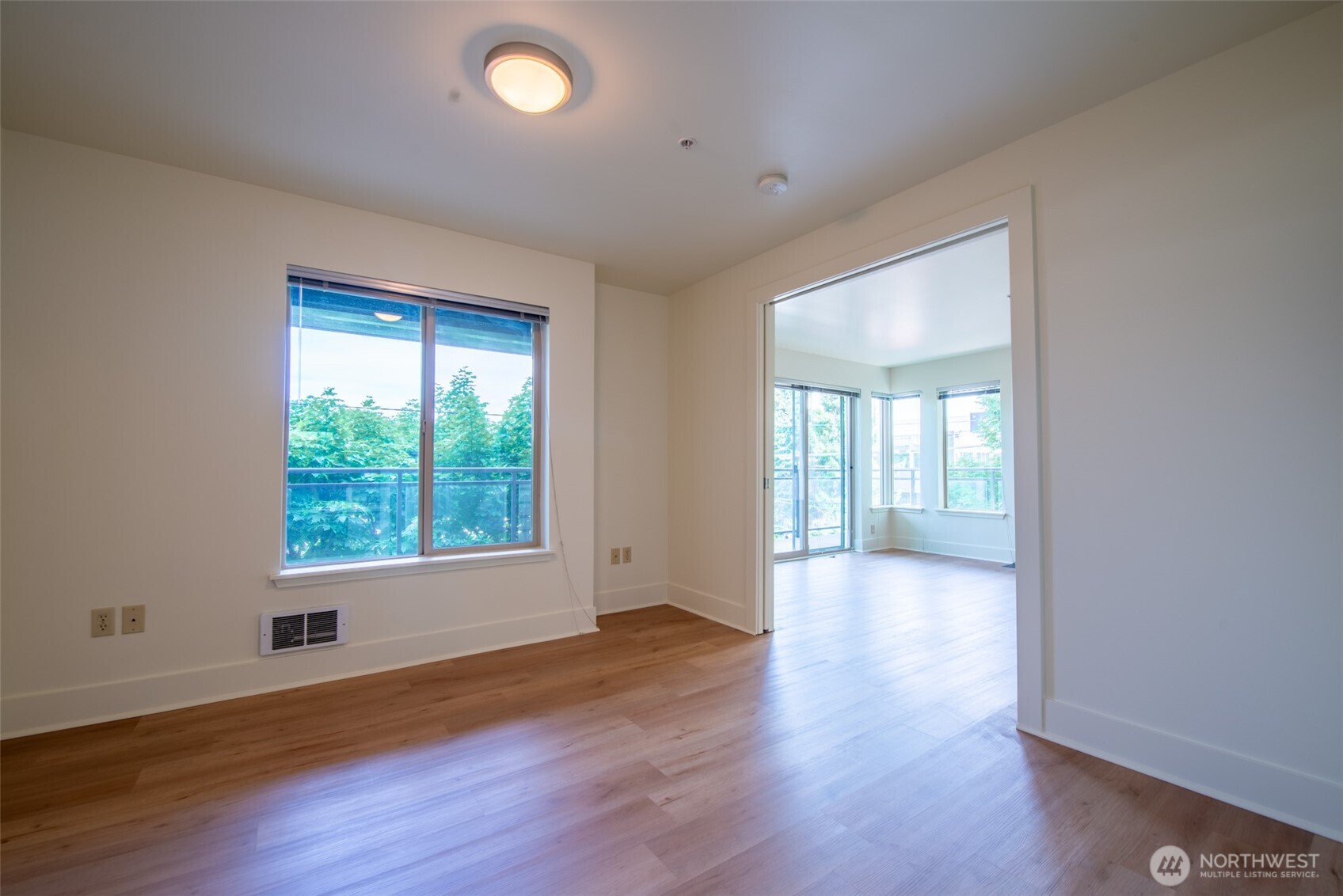 1550 Eastlake Avenue East, Unit 201 Seattle, WA 98102 - Photo 16 of 30 a view of an empty room with wooden floor and a window