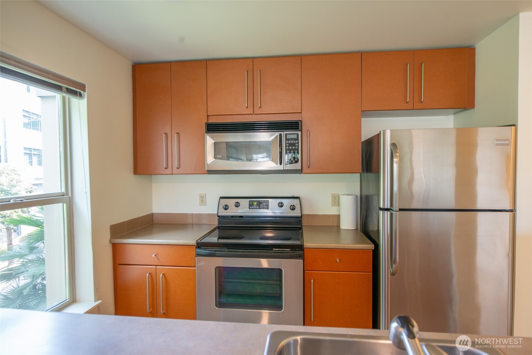 1550 Eastlake Avenue East, Unit 201 Seattle, WA 98102 - Photo 21 of 30 a kitchen with stainless steel appliances granite countertop a refrigerator sink and stove