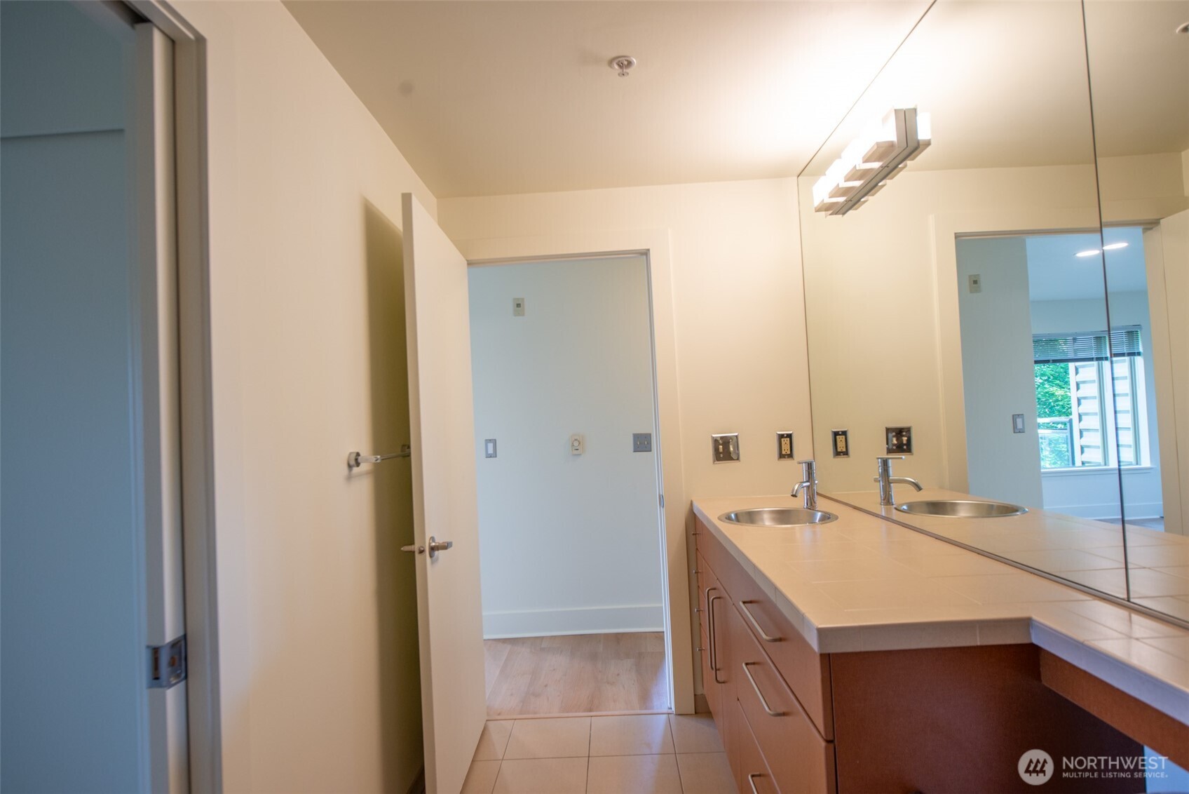 1550 Eastlake Avenue East, Unit 201 Seattle, WA 98102 - Photo 22 of 30 a bathroom with a double vanity sink and mirror