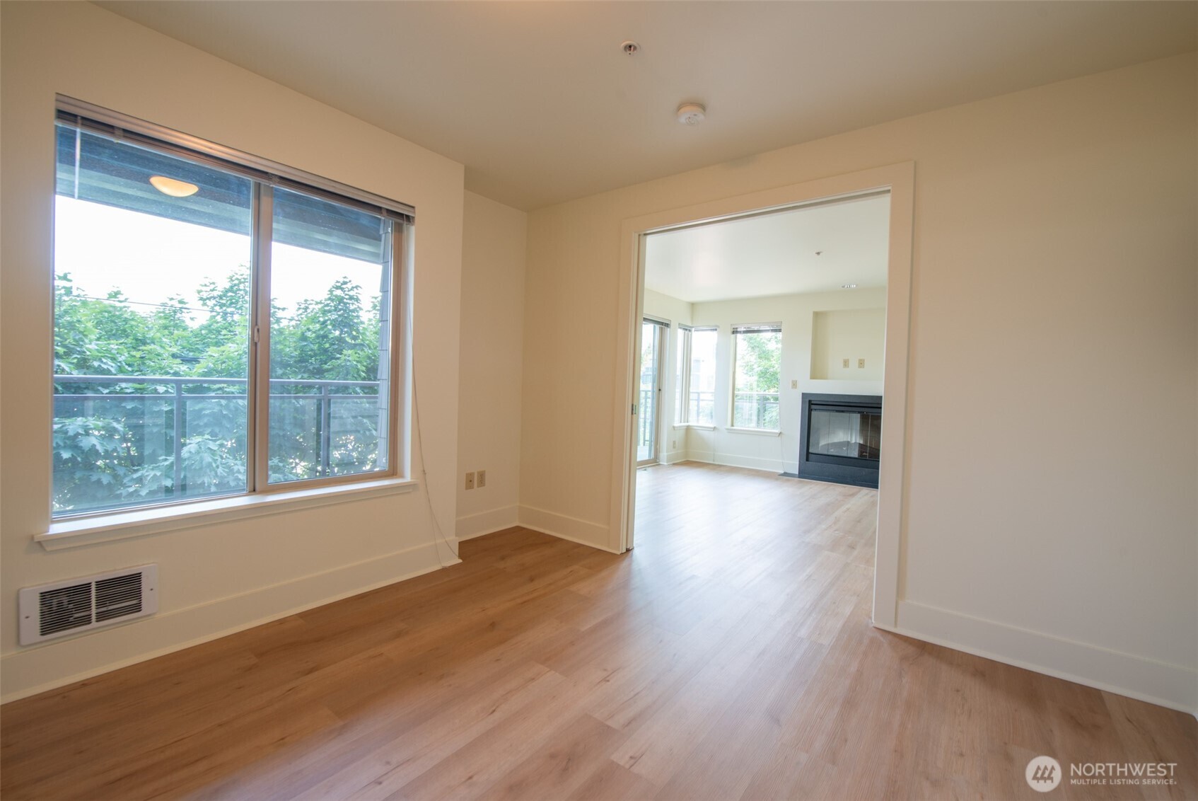 1550 Eastlake Avenue East, Unit 201 Seattle, WA 98102 - Photo 8 of 30 a view of an empty room with wooden floor and a window