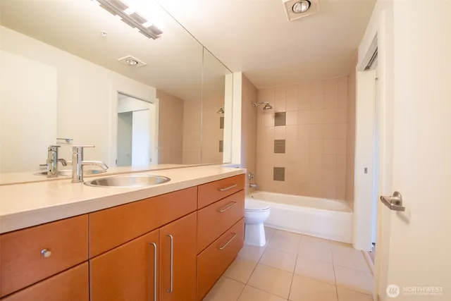 a bathroom with a tub sink shower and a mirror