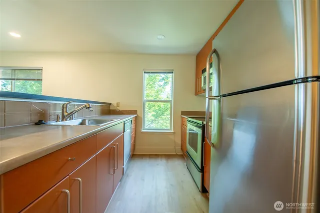 a kitchen with a sink and refrigerator
