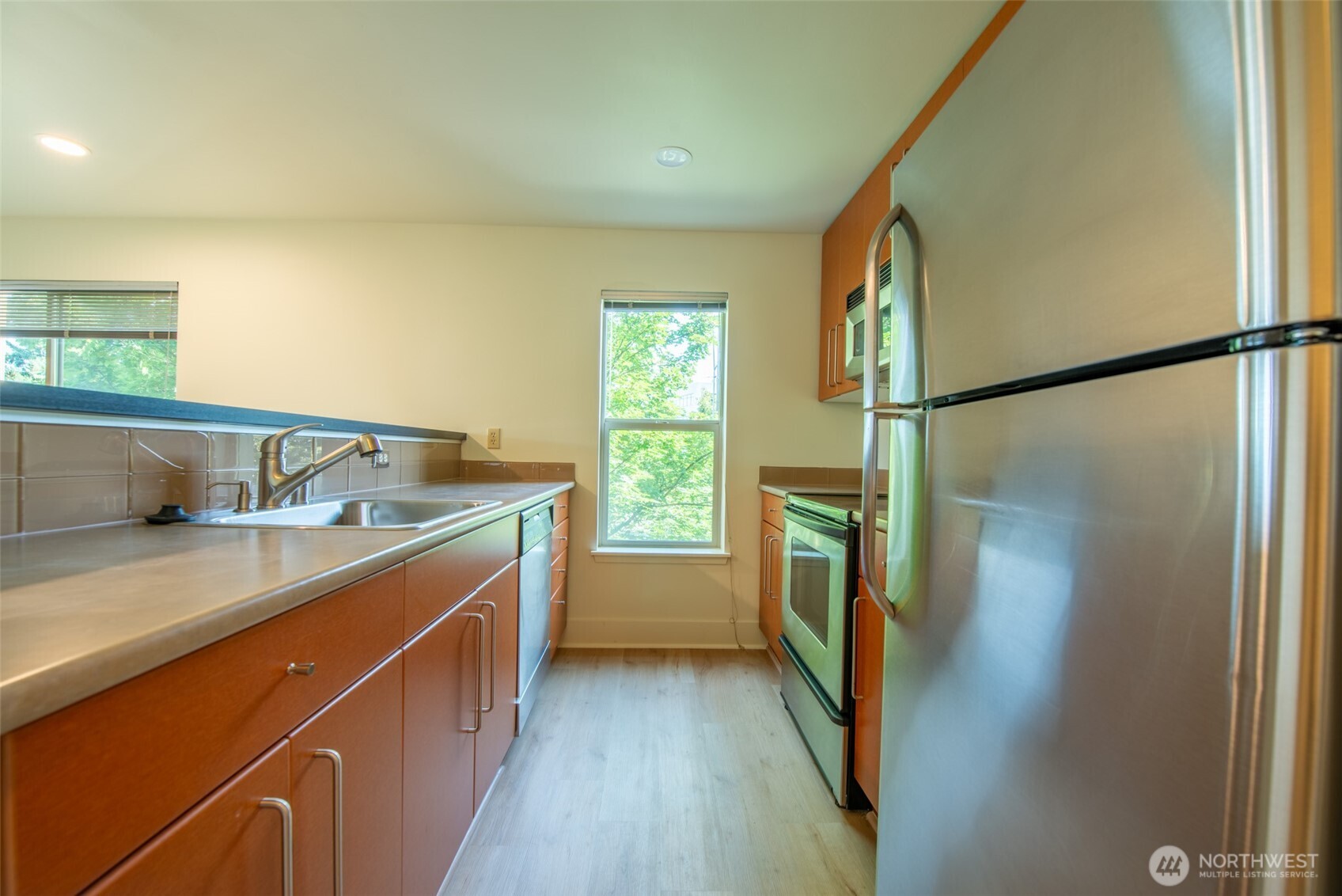 1550 Eastlake Avenue East, Unit 201 Seattle, WA 98102 - Photo 10 of 30 a kitchen with a sink and refrigerator