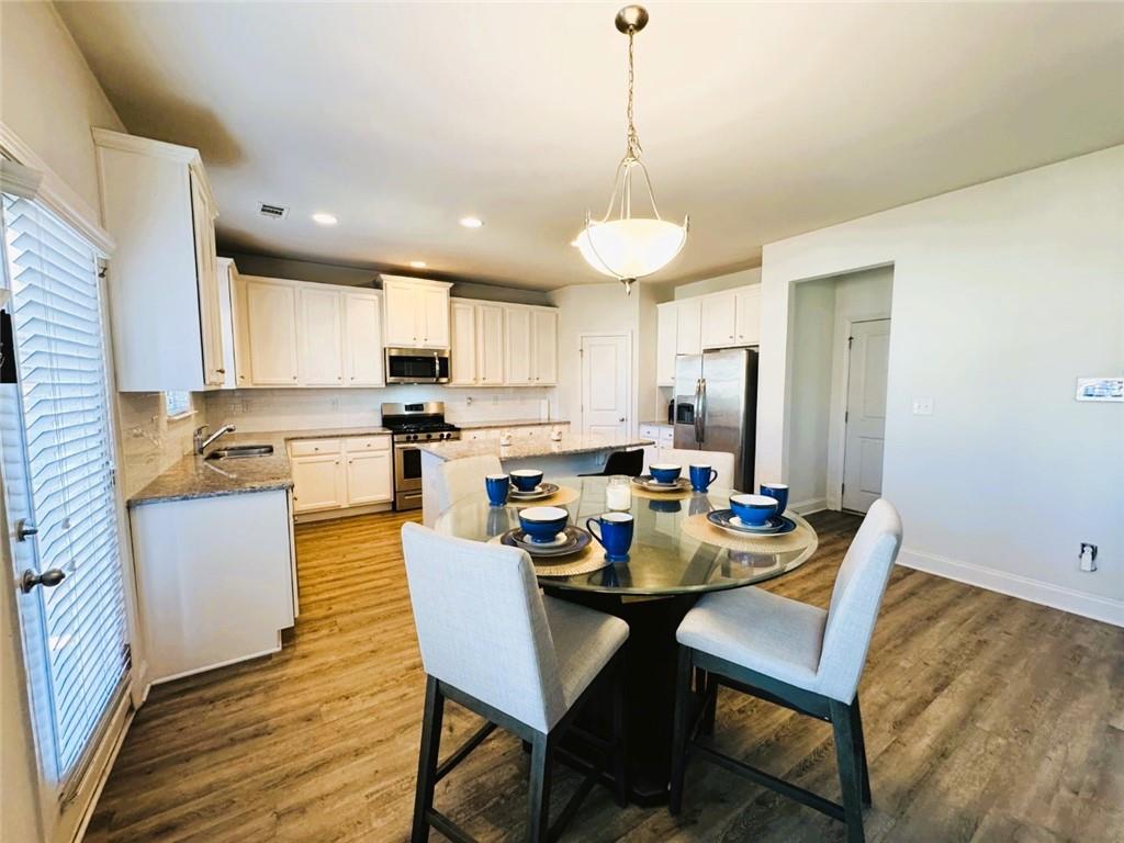 142 Wentworth Lane Villa Rica, GA 30180 - Photo 11 of 44 a view of a dining room and a kitchen with a table chairs