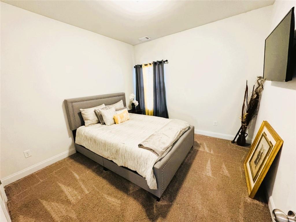 142 Wentworth Lane Villa Rica, GA 30180 - Photo 23 of 44 a bedroom with a bed and flat screen tv