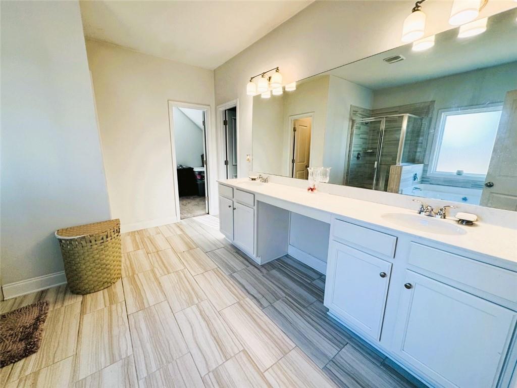 142 Wentworth Lane Villa Rica, GA 30180 - Photo 27 of 44 a spacious bathroom with a double vanity sink and a mirror