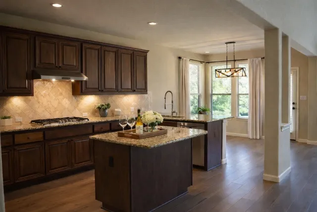 a kitchen with sink cabinets and wooden floor