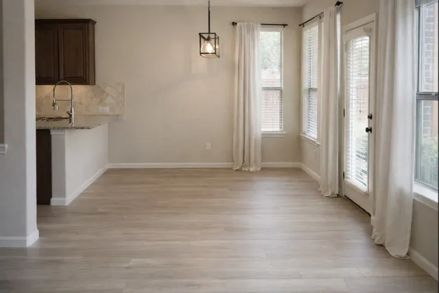 a view of hallway with wooden floor