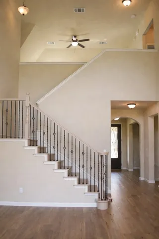 a view of a hallway with wooden floor