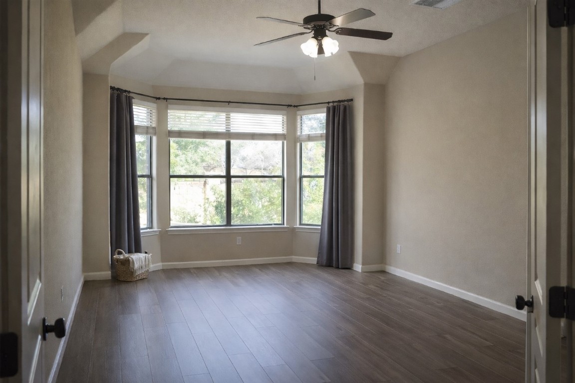 2612 Raindance Leander, TX 78641 - Photo 6 of 8 an empty room with wooden floor fan and windows