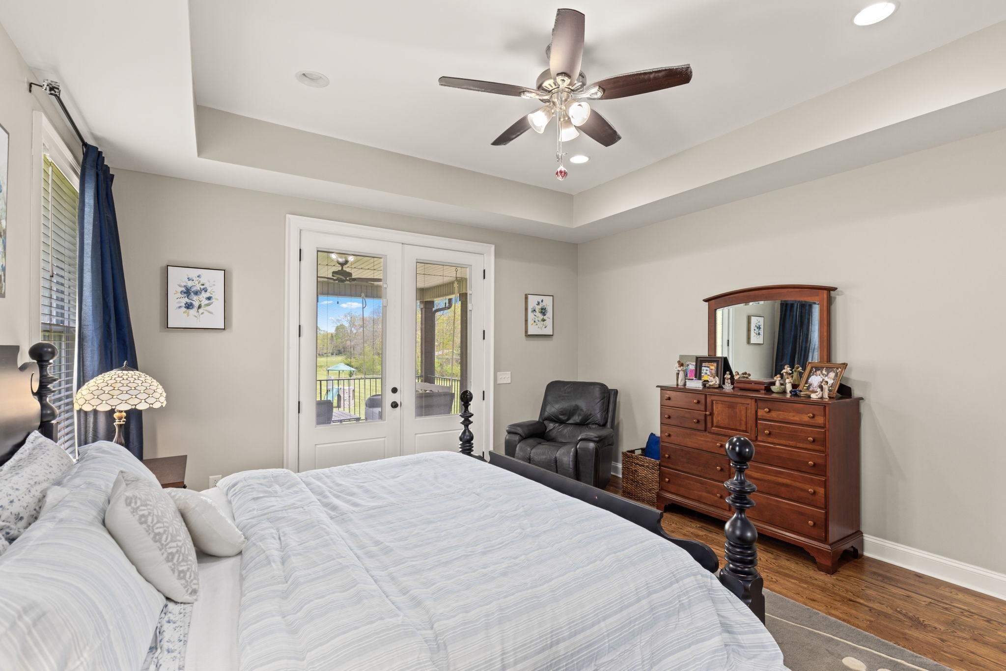 6012 Bethlehem Road Springfield, TN 37172 - Photo 16 of 60 a bedroom with a bed and a chandelier