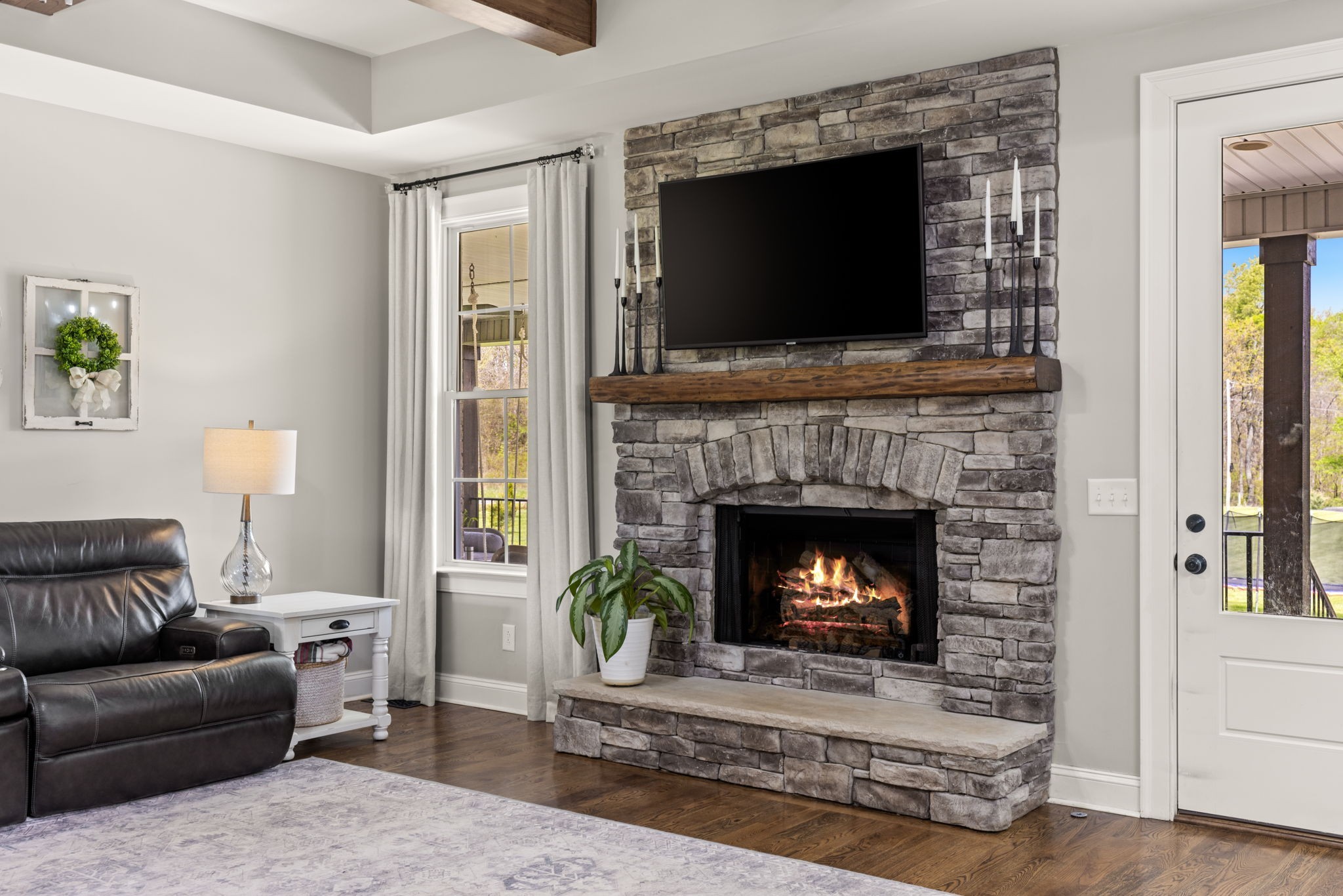 6012 Bethlehem Road Springfield, TN 37172 - Photo 8 of 60 a living room with furniture a flat screen tv and a fireplace