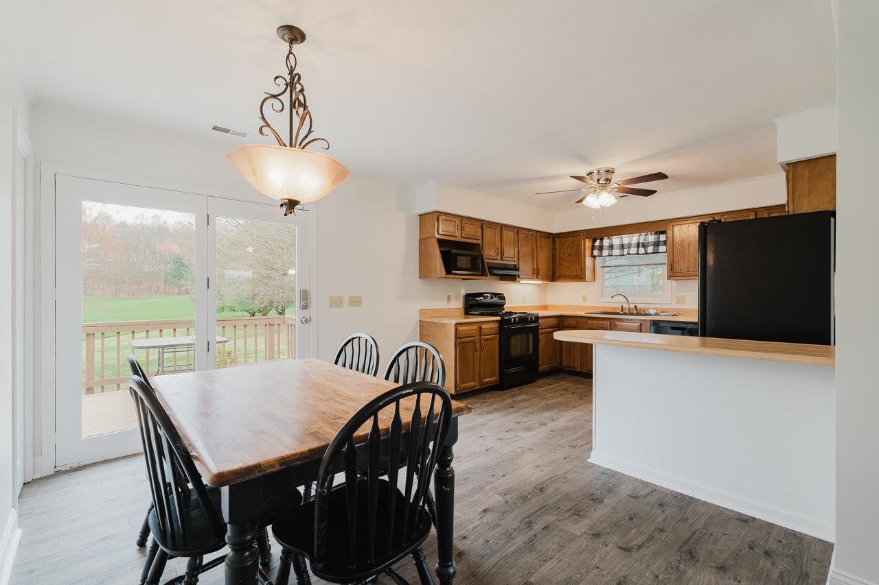 2407 Spaders Church Road Harrisonburg, VA 22801 - Photo 10 of 32 a view of a dining room with furniture large window and wooden floor