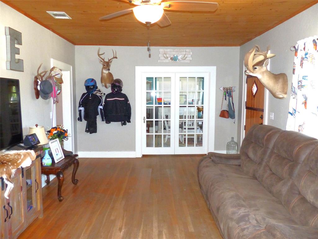 703 Gay Street Menard, TX 76859 - Photo 11 of 37 a living room with furniture and wooden floor