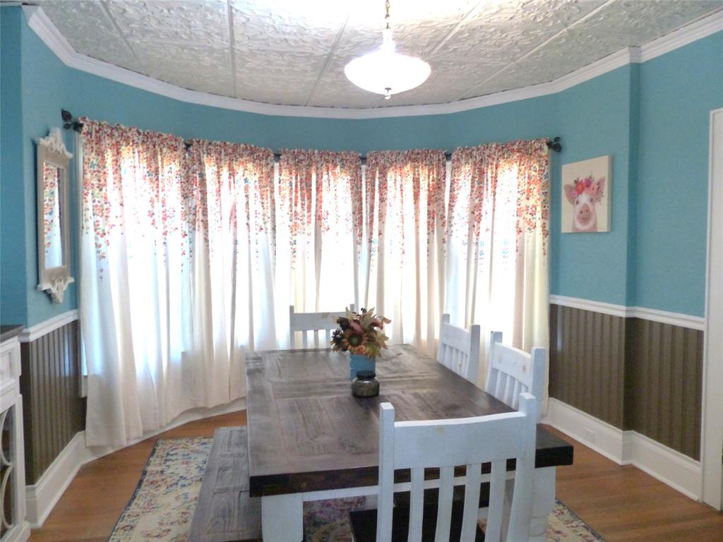703 Gay Street Menard, TX 76859 - Photo 12 of 37 a view of a dining room with furniture window and wooden floor