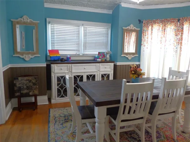 a view of a dining room with furniture and window