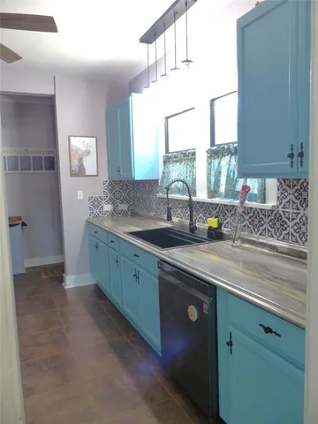 a kitchen with sink and window