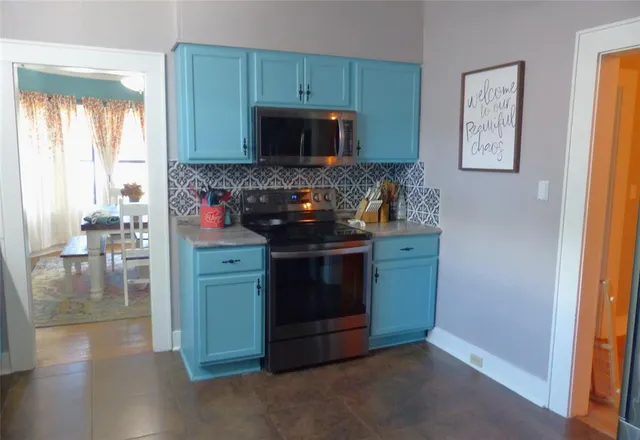 a kitchen with stainless steel appliances granite countertop a stove and a microwave