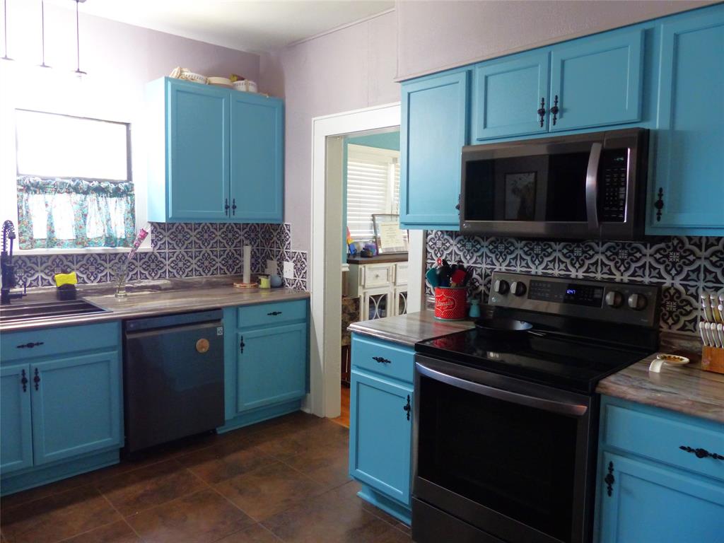 703 Gay Street Menard, TX 76859 - Photo 19 of 37 a kitchen with a stove and a microwave