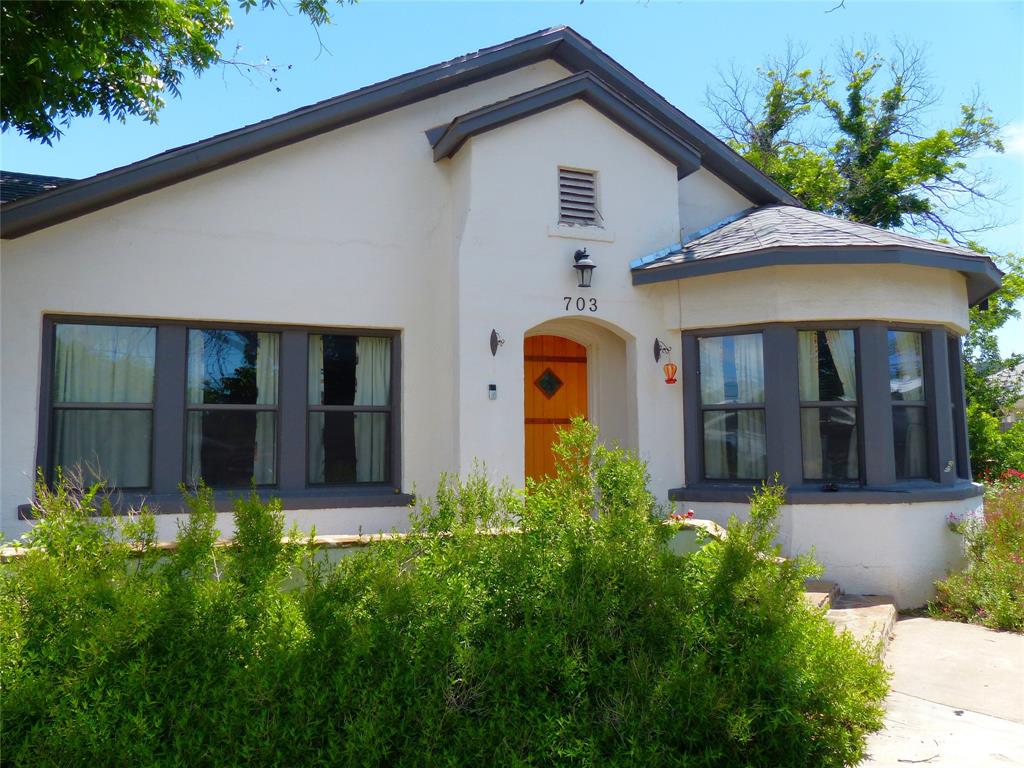 703 Gay Street Menard, TX 76859 - Photo 2 of 37 a front view of a house with garden