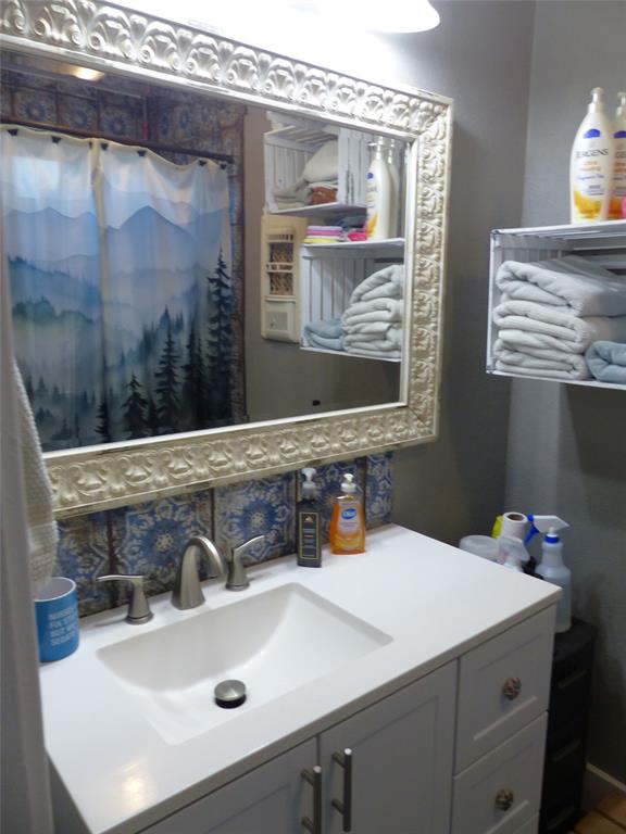 703 Gay Street Menard, TX 76859 - Photo 24 of 37 a bathroom with a sink and a mirror