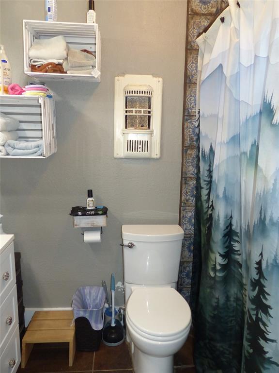 703 Gay Street Menard, TX 76859 - Photo 25 of 37 a white toilet sitting next to a bathroom sink